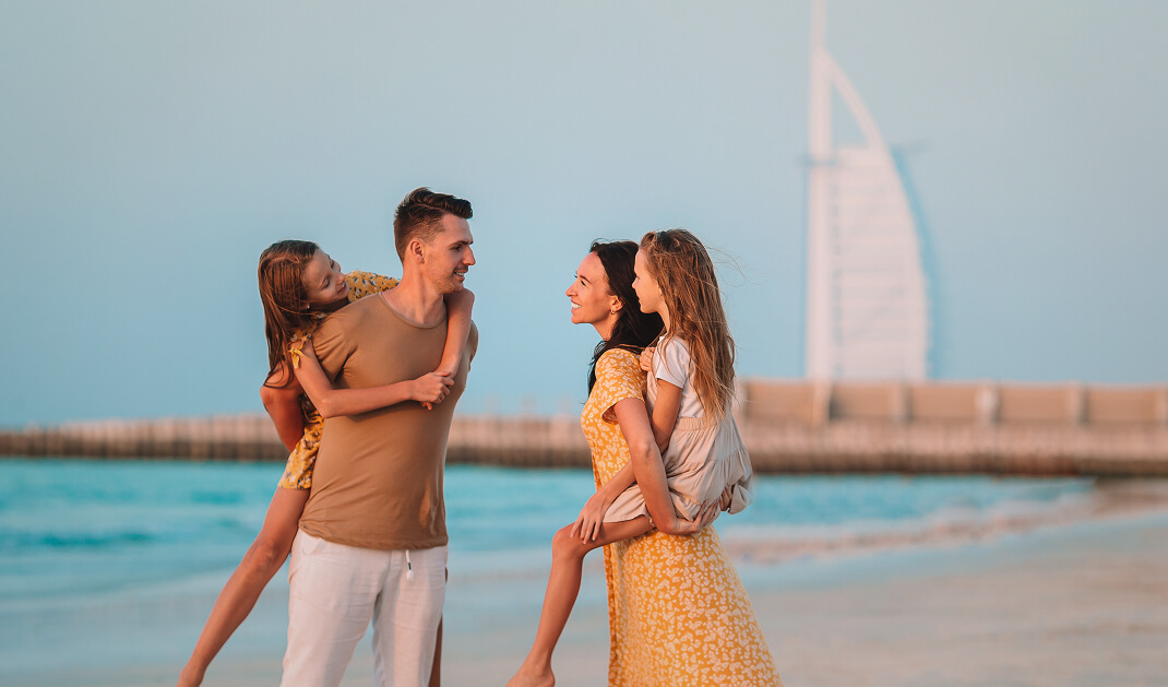 Family on the beach with burj al arab